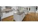 Open kitchen features an island with granite countertops, stainless appliances, and plenty of natural light at 745 Glengate Pl, Atlanta, GA 30328