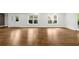 Spacious living room with hardwood floors, white trim, and multiple windows for natural light at 745 Glengate Pl, Atlanta, GA 30328