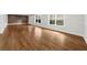 Bright living room with hardwood floors, two windows, and a charming brick wall feature at 745 Glengate Pl, Atlanta, GA 30328