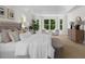 Bright main bedroom with neutral tones, large windows, and a cozy seating area at 745 Glengate Pl, Atlanta, GA 30328