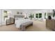 Bright main bedroom with neutral tones, large windows, and a cozy seating area at 745 Glengate Pl, Atlanta, GA 30328