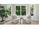 A bright sitting area featuring a pair of elegant armchairs near a set of bright windows at 745 Glengate Pl, Atlanta, GA 30328