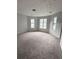 Bright and airy bedroom with plush carpeting, ample natural light, and a neutral color palette at 1081 Forest Path, Stone Mountain, GA 30088