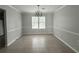 Spacious dining room featuring neutral tones, tile flooring, and classic chandelier lighting at 1081 Forest Path, Stone Mountain, GA 30088