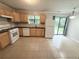 Functional kitchen features sleek countertops, modern appliances, tile floors, and sliding glass doors at 1081 Forest Path, Stone Mountain, GA 30088