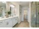 Modern bathroom with dual sinks, tile flooring, and glass-enclosed shower at 6139 Wayburn St, Tucker, GA 30084