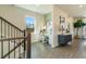 Inviting entryway with hardwood floors, staircase, study nook, and stylish decor at 6139 Wayburn St, Tucker, GA 30084