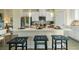 Bright, modern kitchen with white cabinets, stainless steel appliances and center island with seating at 6139 Wayburn St, Tucker, GA 30084