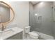 Contemporary bathroom with glass shower, marble vanity top, and decorative mirror at 10904 Serenbe Ln, Chattahoochee Hills, GA 30268