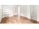 Light-filled bedroom with hardwood floors, built-in shelving, and ensuite bath with tub and shower at 10904 Serenbe Ln, Chattahoochee Hills, GA 30268