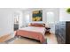 Cozy bedroom with stylish decor, featuring a queen bed, a dresser and an ensuite bathroom at 10904 Serenbe Ln, Chattahoochee Hills, GA 30268