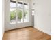 Sun-filled room features large windows, hardwood flooring, and neutral walls at 10904 Serenbe Ln, Chattahoochee Hills, GA 30268