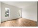 Bright, empty bedroom features hardwood floors, white walls, and natural light from two windows at 10904 Serenbe Ln, Chattahoochee Hills, GA 30268