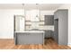 Stylish kitchen with an island, quartz countertops, gray cabinets, and pendant lighting at 10904 Serenbe Ln, Chattahoochee Hills, GA 30268