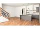 Open-concept living room and kitchen with hardwood floors and staircase at 10904 Serenbe Ln, Chattahoochee Hills, GA 30268