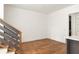 Open living space with hardwood floors, a staircase, and an open view at 10904 Serenbe Ln, Chattahoochee Hills, GA 30268