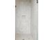 Luxurious tiled shower with herringbone floor, a built-in niche and glass enclosure at 10904 Serenbe Ln, Chattahoochee Hills, GA 30268