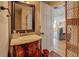 Elegant bathroom featuring a dark wood vanity with marble countertop and a decorative mirror at 22 Waters Bridge Cir, Covington, GA 30014