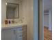 Bathroom featuring white vanity and a glimpse into the bedroom at 22 Waters Bridge Cir, Covington, GA 30014