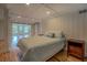 Bright bedroom featuring hardwood floors, an attached room and a sliding barn door at 22 Waters Bridge Cir, Covington, GA 30014