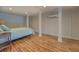 Cozy bedroom featuring hardwood floors, white paneling, and a comfortable bed at 22 Waters Bridge Cir, Covington, GA 30014