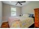 Cozy bedroom featuring hardwood floors, natural light, and decorative bedding at 22 Waters Bridge Cir, Covington, GA 30014