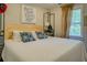 Comfortable bedroom with a white quilt, decorative pillows, and natural light at 22 Waters Bridge Cir, Covington, GA 30014