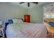 Comfortable bedroom with a colorful quilt, hardwood floors, and access to the living area at 22 Waters Bridge Cir, Covington, GA 30014