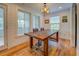 Bright dining area with natural light, shiplap walls, wood floors, and an antler chandelier at 22 Waters Bridge Cir, Covington, GA 30014