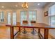 Dining area with shiplap walls, wood floors, and a wooden table with stools at 22 Waters Bridge Cir, Covington, GA 30014