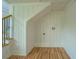 Hallway with wooden floors, stairs, and electrical outlets at 22 Waters Bridge Cir, Covington, GA 30014