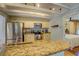Spacious kitchen with granite countertops and stainless steel appliances open to the dining area at 22 Waters Bridge Cir, Covington, GA 30014