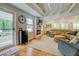Cozy living room featuring a fireplace, beamed ceilings, hardwood floors and plenty of natural light at 22 Waters Bridge Cir, Covington, GA 30014