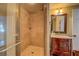 Modern shower with neutral tile surround, glass door, and updated fixtures in renovated bathroom at 22 Waters Bridge Cir, Covington, GA 30014