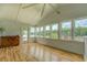 Inviting sunroom filled with natural light and lake views, accentuated by beautiful hardwood floors at 22 Waters Bridge Cir, Covington, GA 30014
