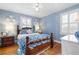 Comfortable bedroom features a four-poster bed, hardwood floors, and natural light from two windows at 255 Maple Nw Ave, Marietta, GA 30064
