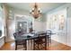 Formal dining room with a chandelier and built-in cabinets with glass doors at 255 Maple Nw Ave, Marietta, GA 30064