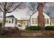 Exterior shot of the home features a brick chimney and front porch with white pillars at 255 Maple Nw Ave, Marietta, GA 30064