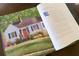 Book featuring well-maintained home with red door and a well-manicured lawn at 255 Maple Nw Ave, Marietta, GA 30064