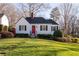 Well-maintained front yard and a charming front facade with a vibrant red door at 255 Maple Nw Ave, Marietta, GA 30064