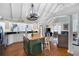 Bright kitchen with white cabinets, an island with an attached breakfast bar, and vaulted ceilings at 255 Maple Nw Ave, Marietta, GA 30064