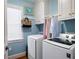 Well-lit laundry room with modern washer and dryer units and ample storage at 255 Maple Nw Ave, Marietta, GA 30064