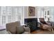 Close up of a cozy chair, fireplace and windows in a home's living room at 255 Maple Nw Ave, Marietta, GA 30064