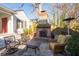 Outdoor patio with brick fireplace, comfortable seating, and elegant stone flooring, perfect for entertaining at 255 Maple Nw Ave, Marietta, GA 30064