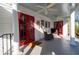 Charming front porch features red doors, a ceiling fan, and comfortable seating at 255 Maple Nw Ave, Marietta, GA 30064
