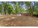 Expansive backyard with mature trees, and a brick house with white trim at 3152 Ridgecrest Dr, Powder Springs, GA 30127