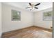 Inviting bedroom with new flooring, ceiling fan, and natural light from two windows at 3152 Ridgecrest Dr, Powder Springs, GA 30127