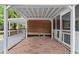 Covered patio with a brick floor, white painted beams, and an attached fence at 3152 Ridgecrest Dr, Powder Springs, GA 30127