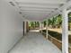 Long covered patio with concrete floor, white support beams and direct access to the backyard at 3152 Ridgecrest Dr, Powder Springs, GA 30127