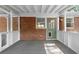 Charming covered porch featuring painted wood structure, brick wall, and a green door with a dog door at 3152 Ridgecrest Dr, Powder Springs, GA 30127